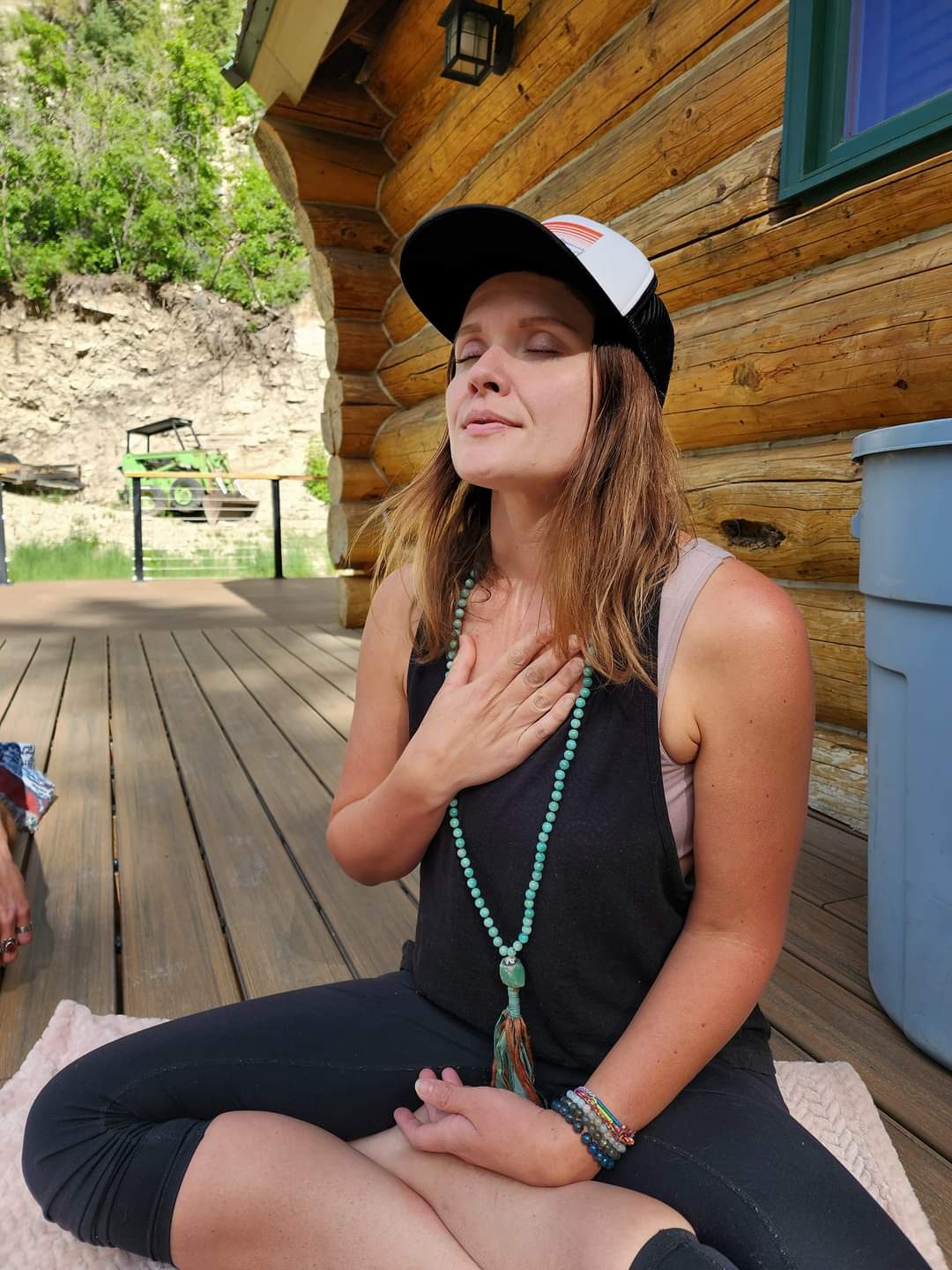 Ember, eyes closed with a hand on her heart