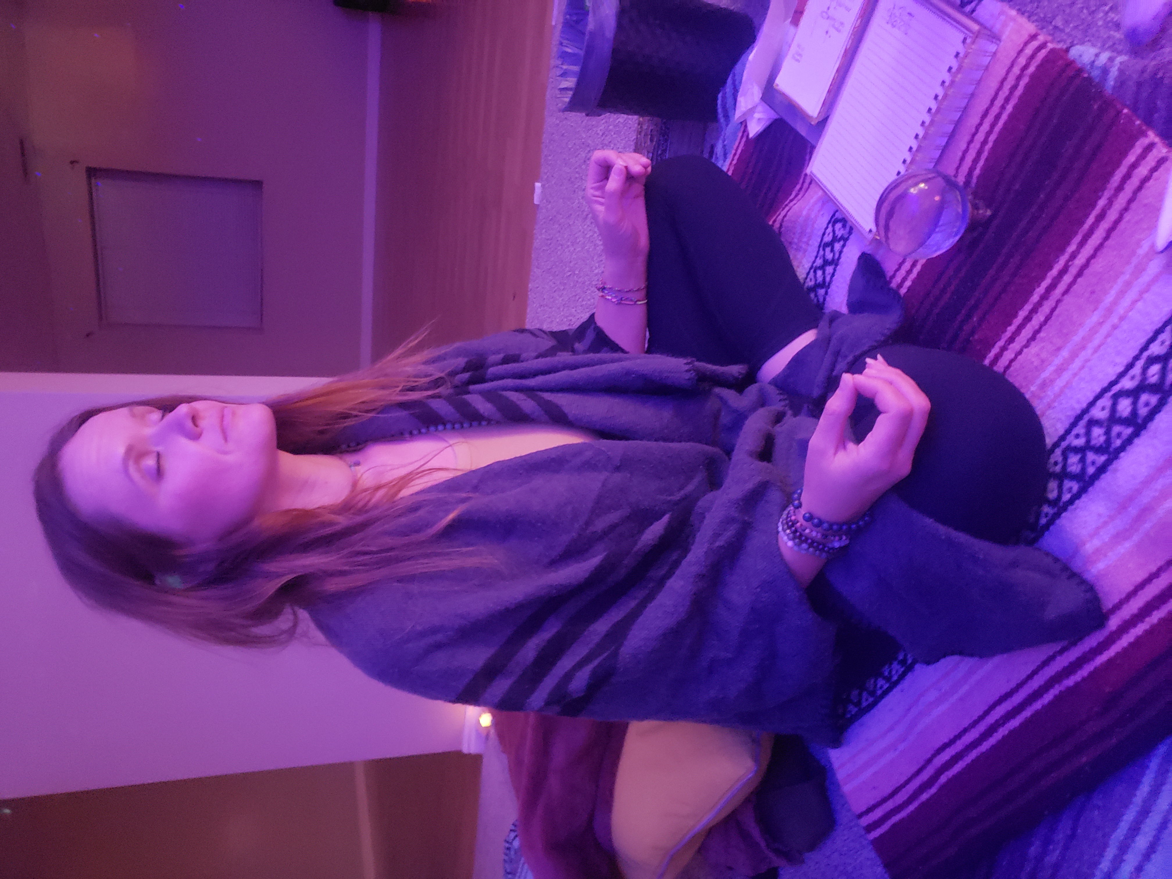 Ember sitting in meditation during a channeling session