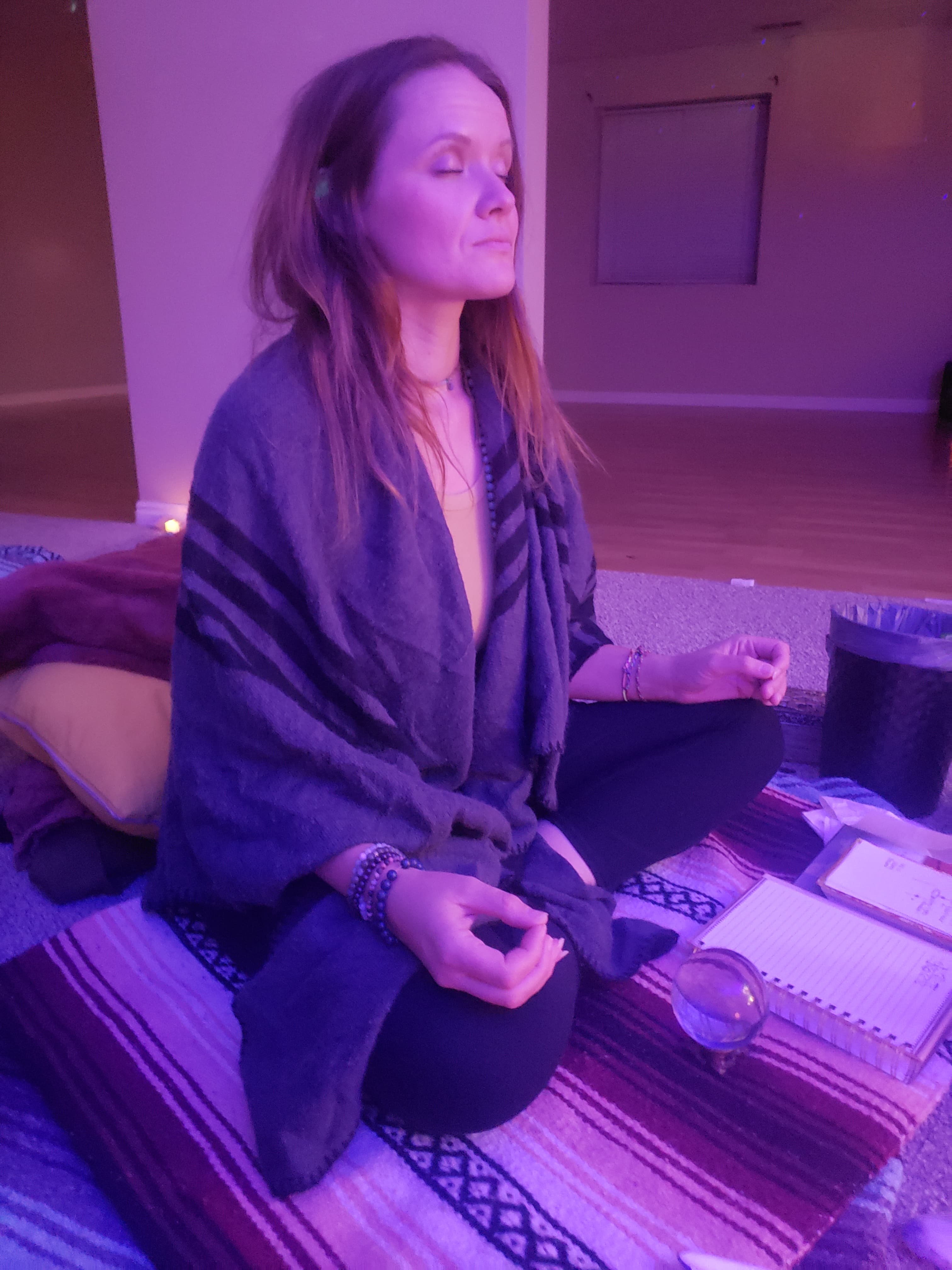 Ember sitting in meditation during a channeling session